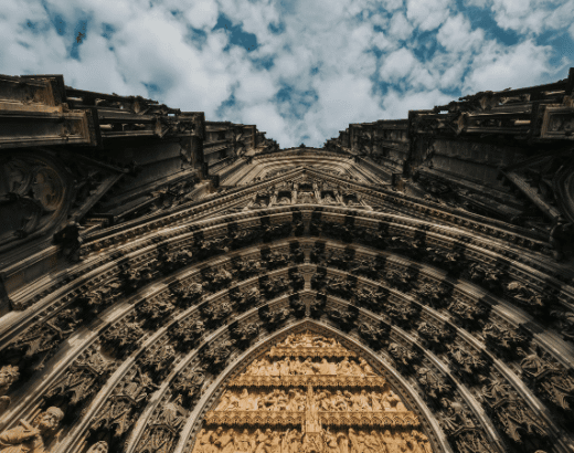 Detailaufnahme der Domfassade in Köln aus der Froschperspektive am Abend